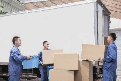 Local removal vehicle loading business furniture for a move in Epsom