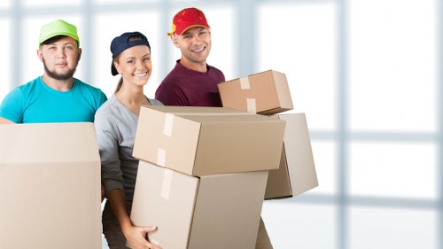 Local office movers handling desks and furniture during an Epsom business relocation