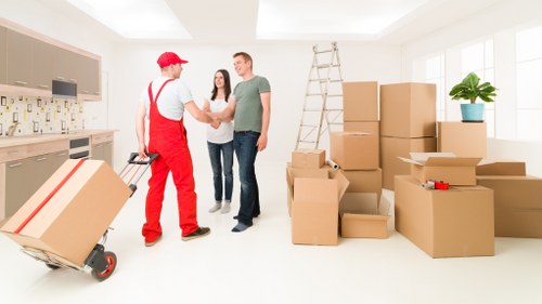 Mover using PPE and moving tools to protect furniture during loading