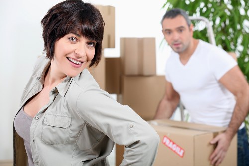 Packed household boxes and furniture prepared for a move in Epsom